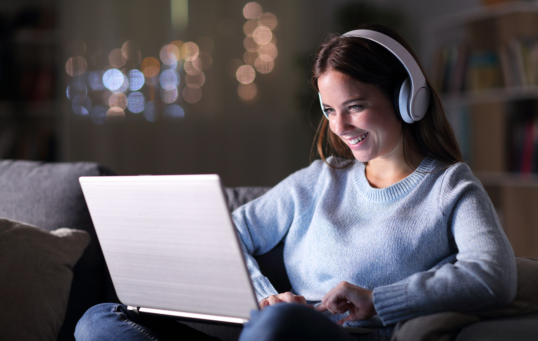 Woman with Headphones on Her Laptop